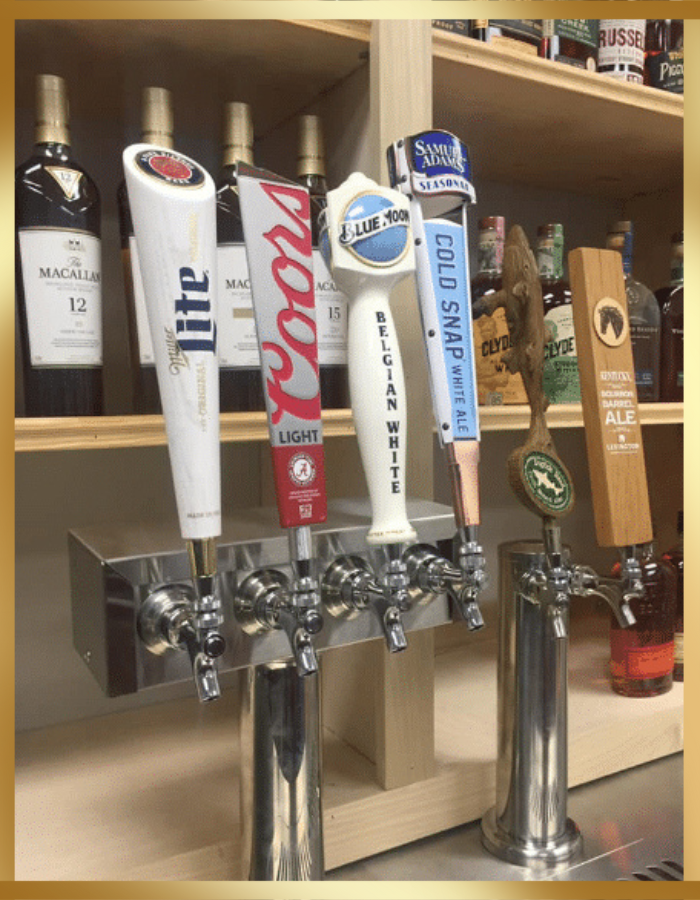 A close-up of a beer tap system featuring four different tap handles, including Coors Light, for dispensing beverages.